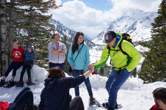 A Pivot Adventure guide helps students snowshoe in the mountains.