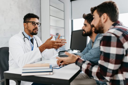 Gay couple together visiting doctor. Homosexuality concept. Gay couple together visiting doctor. Homosexuality concept.