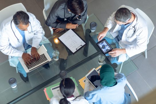 Medical team working together at table in hospital Medical team working together at table in hospital